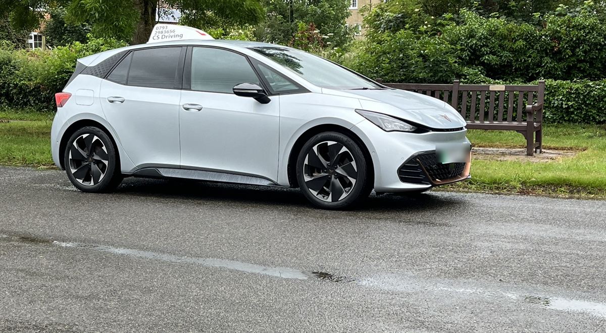 CS Driving's silver Cupra Born electric tuition car with roof sign